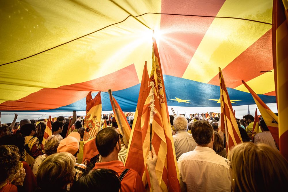 Anti-separatist Catalans shout slogans as they march through the city of Barcelona as they protest for the indivisibility Spain's two days after a suspended independence declared by the pro-separatist Catalan Government