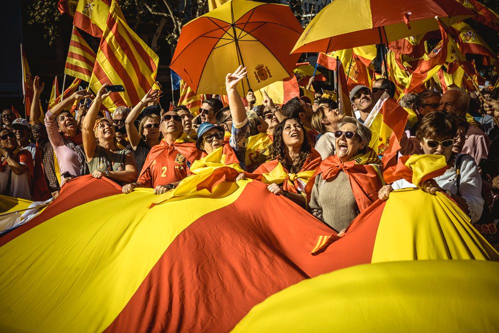 Barcelona, Spain. 29 October, 2017: 
Anti-separatist Catalans march with a giant Catalan flag through the city of Barcelona as they protest for the indivisibility Spain's two days after the Catalan parliament has voted and the Spanish central government triggered article 155 to take control over the region