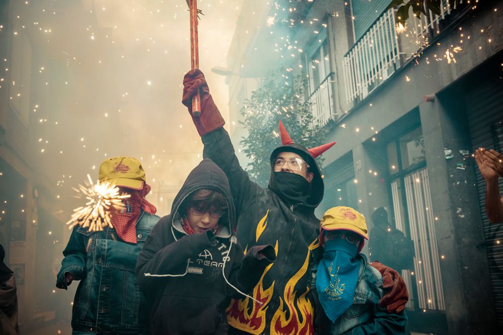 August 21st, 2014. Barcelona, Spain: Children in devil costumes dance to traditional drums under fireworks during the "Correfocs" at the "Festa Major de Gracia".