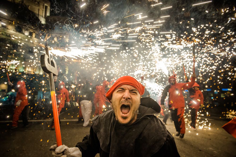 Barcelona, Spain. September 21st, 2014: A devil shouts as he sets off his fire crackers dancing in the street during the Merce 2014