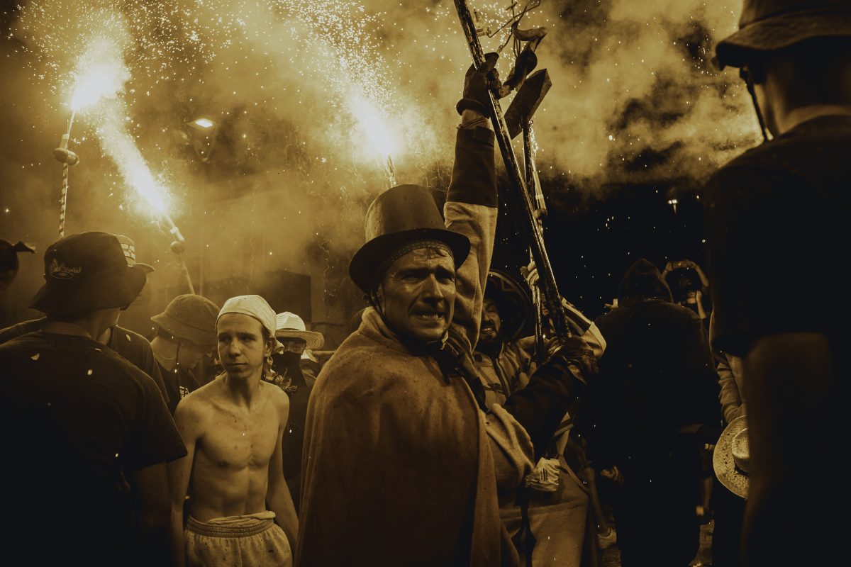 Sitges, Spain. 5 July, 2024: A fire runner dances to traditional drums under sparks during some 'correfocs' in Sitges