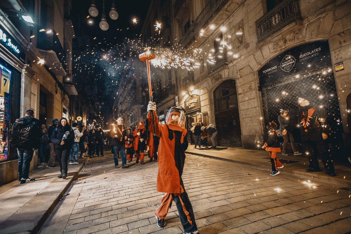 Little fire runners in devil costumes dance to traditional drums under fireworks during the children 'Correfocs' (fire-runs) at Barcelona's winter city festival 'Santa Eulalia' 2026'