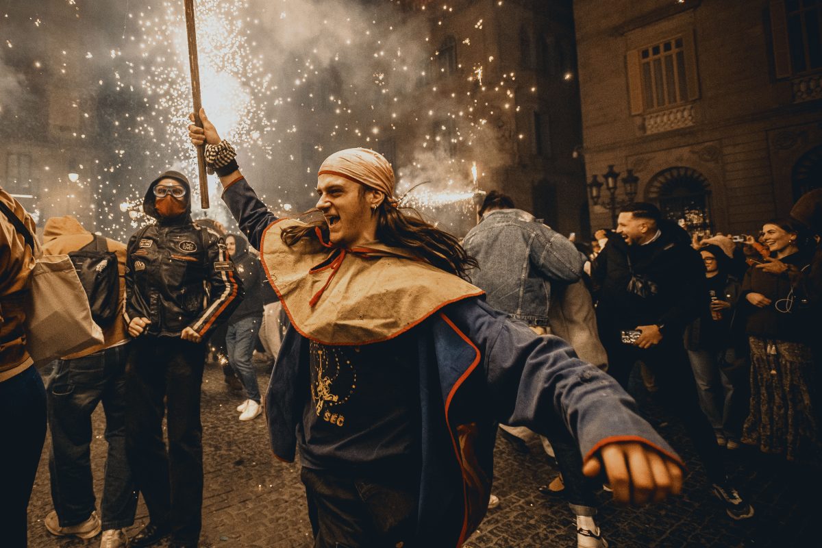 Fire runners in devil costumes dance to traditional drums under fireworks during the 'Correfocs' (fire-runs) at Barcelona's winter city festival 'Santa Eulalia' 2026'