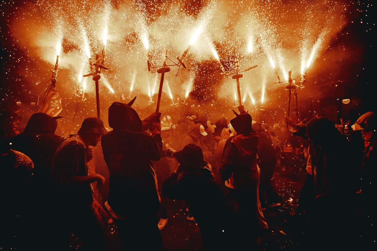 Fire runners in devil costumes charge to drumbeats through a spray of sparking firecrackers in the ‘Correfocs’ at Barcelona’s iconic ‘Festa Major de Gracia.’