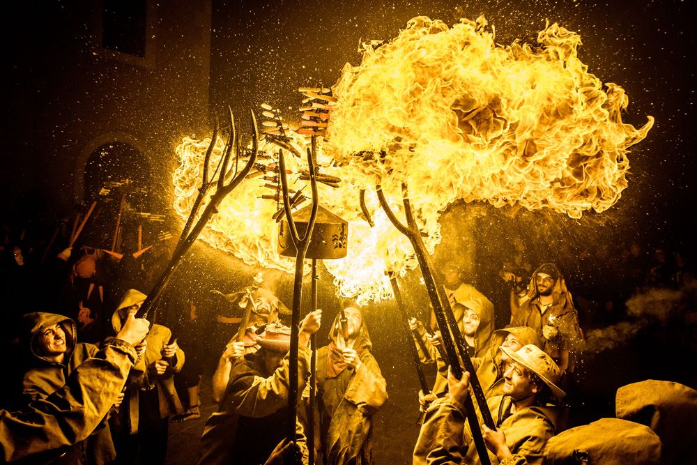 September 17th, 2016. Sitges, Spain: A fire-eater of the 'Diables de Terrassa' enlightens the fireworks of his gathered comrades during Sitges' little 'Festa Major', 'Santa Tecla'