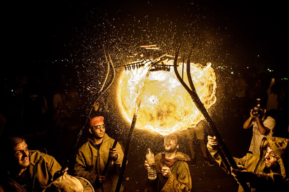 September 17th, 2016. Sitges, Spain: A fire-eater of the 'Diables de Terrassa' enlightens the fireworks of his gathered comrades during Sitges' little 'Festa Major', 'Santa Tecla'