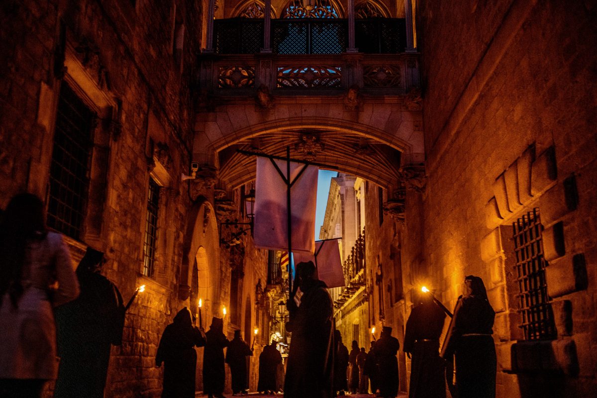 Hooded penitents from the 'Congregacion del Santisimo Cristo de la Buena Muerte' brotherhood walk the nightly streets of Barcelona during their Palm Sunday procession