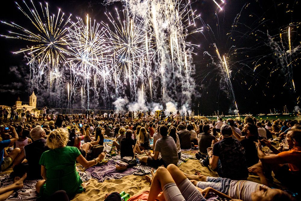 Sitges, Spain. 23 August, 2017: Tens of thousands follow the traditional display of fireworks at the 'San Bartolome' church taking place every 23rd of August during the 'Festa Major de Sitges'.