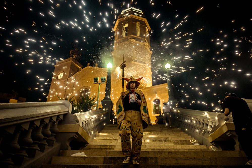 Sitges, Spain. 24 August, 2016: A member of 'Ball de diables' sets off his fireworks as he walks down the 'Escalera de Punta' during  the 'Festa Major de Sitges'.