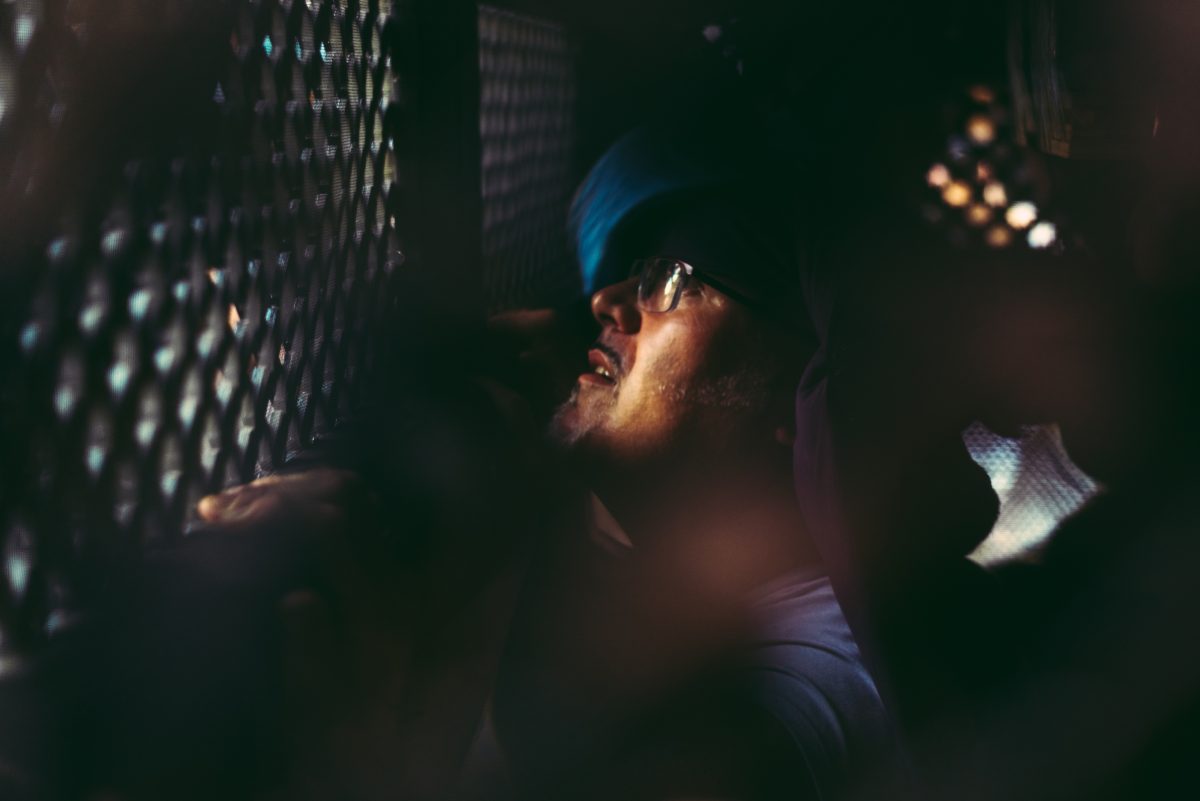 A 'costalero' (porter) is seen through the fine grid of the religious image of the 'Nuestra Senora de las Angustias' brotherhood during the Good Friday procession through Barcelona