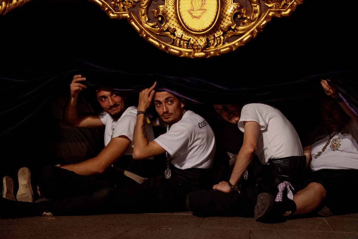 'Costaleros' who carry the float with the religious image of the 'Nuestra Senora de las Angustias' brotherhood the narrow streets of Barcelona's Gothic Quarter have a break during the Good Friday procession