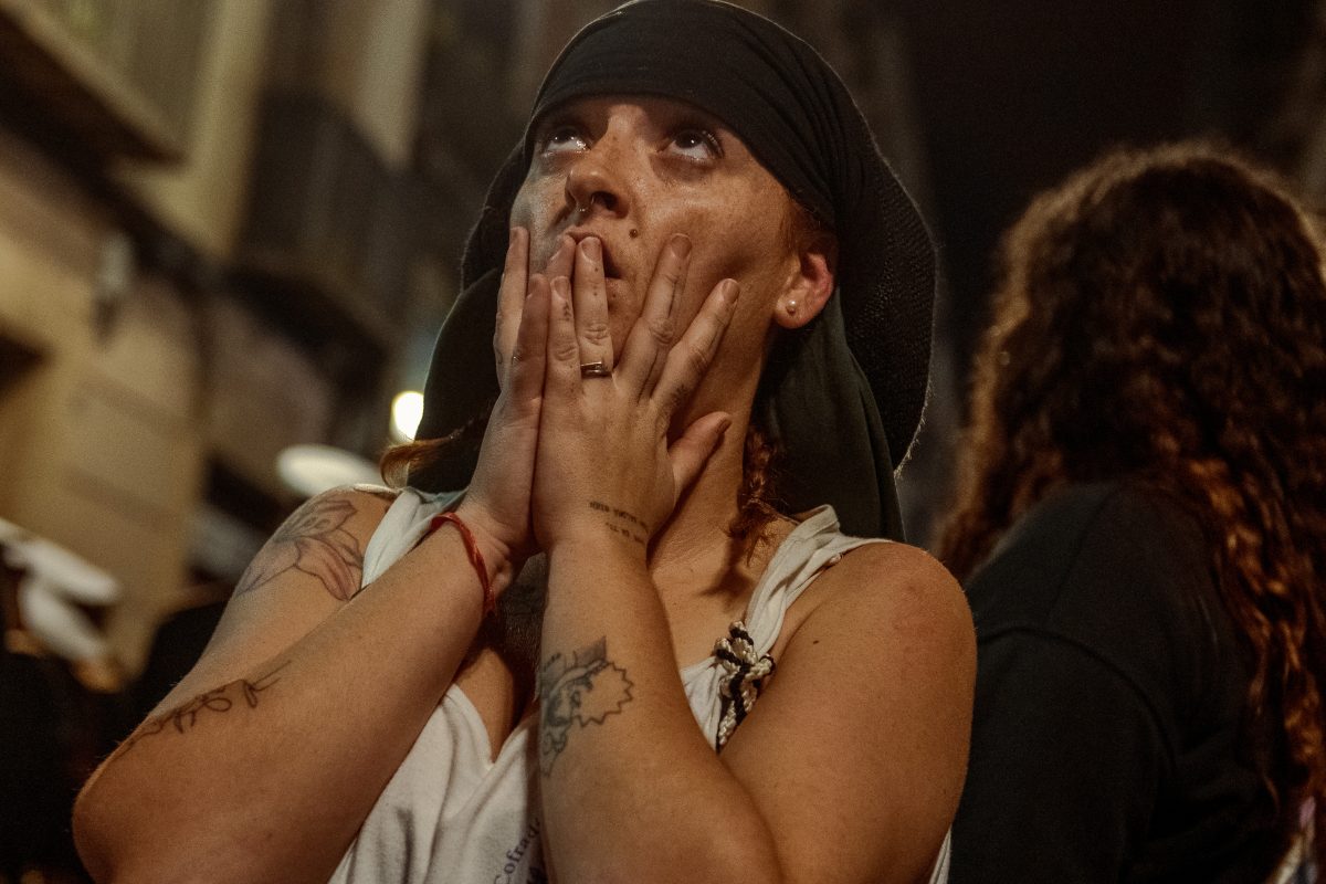 A 'costalero' (porter) of the 'Nuestra Senora de las Angustias' brotherhood reacts as they reach with their float Barcelona's St Jaume church at the end of the Good Friday procession