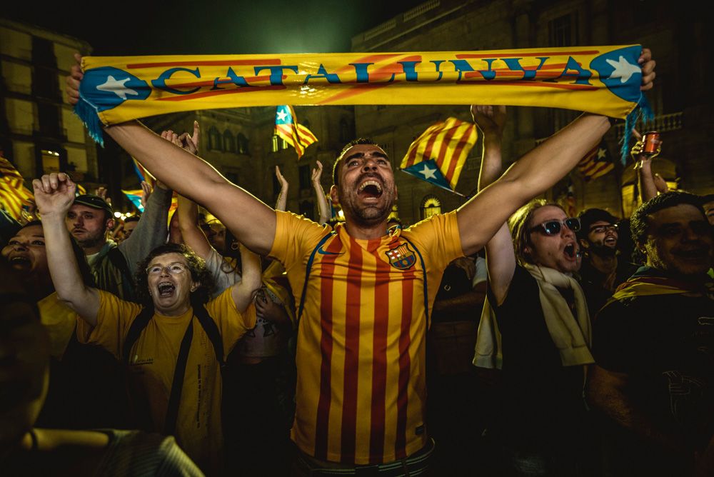 Barcelona, Spain. 27 October, 2017: A Catalan separatist holds a scarf as he celebrates the parliaments independence vote in front of the 'Generalitat' shouting slogans