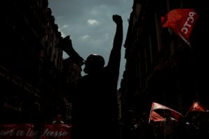 Communists shout slogans as they demonstrate for the working class marching through Barcelona at labor day.