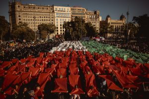 Barcelona, Spain. 20 April, 2024: Protesters against Israel's ongoing attacks on the Gaza Strip, which have led to numerous civilian deaths, form a large human mosaic representing the Palestinian flag. Israles attacks are a reacting to an attack by the Islamist organization Hamas on 7 October.