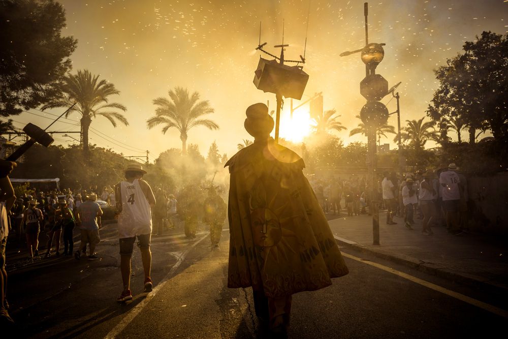 Sitges, Spain. 23 August, 2015: A member of 'Diables de Sitges - colla jove' sets off his fireworks among the crowd of spectators at the 'Festa Major de Sitges'.