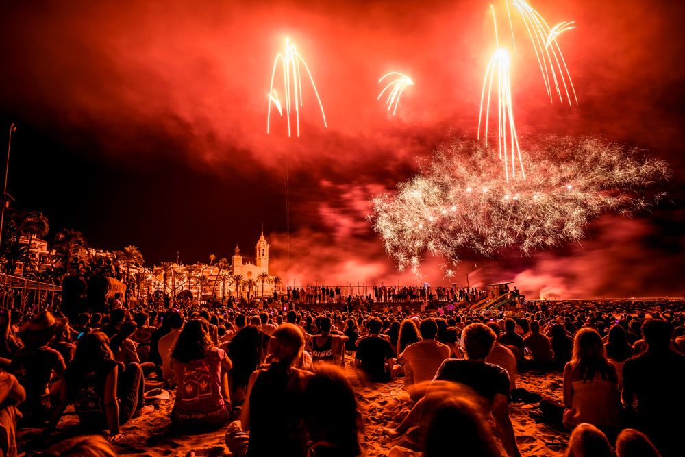 Sitges, Spain. 23 August, 2015: Thousands follow the traditional display of fireworks at the 'San Bartolomé' church taking place every 23rd of August during the 'Festa Major de Sitges'.