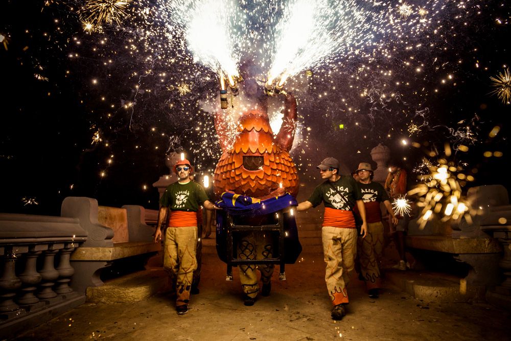 Sitges, Spain. 24 August, 2015: The 'Aliga (Eagle) de Sitges', a folkloric symbol, sets off his fireworks as he walks down the stairs of the 'St Bartolome Church' during the 'Festa Major de Sitges'.