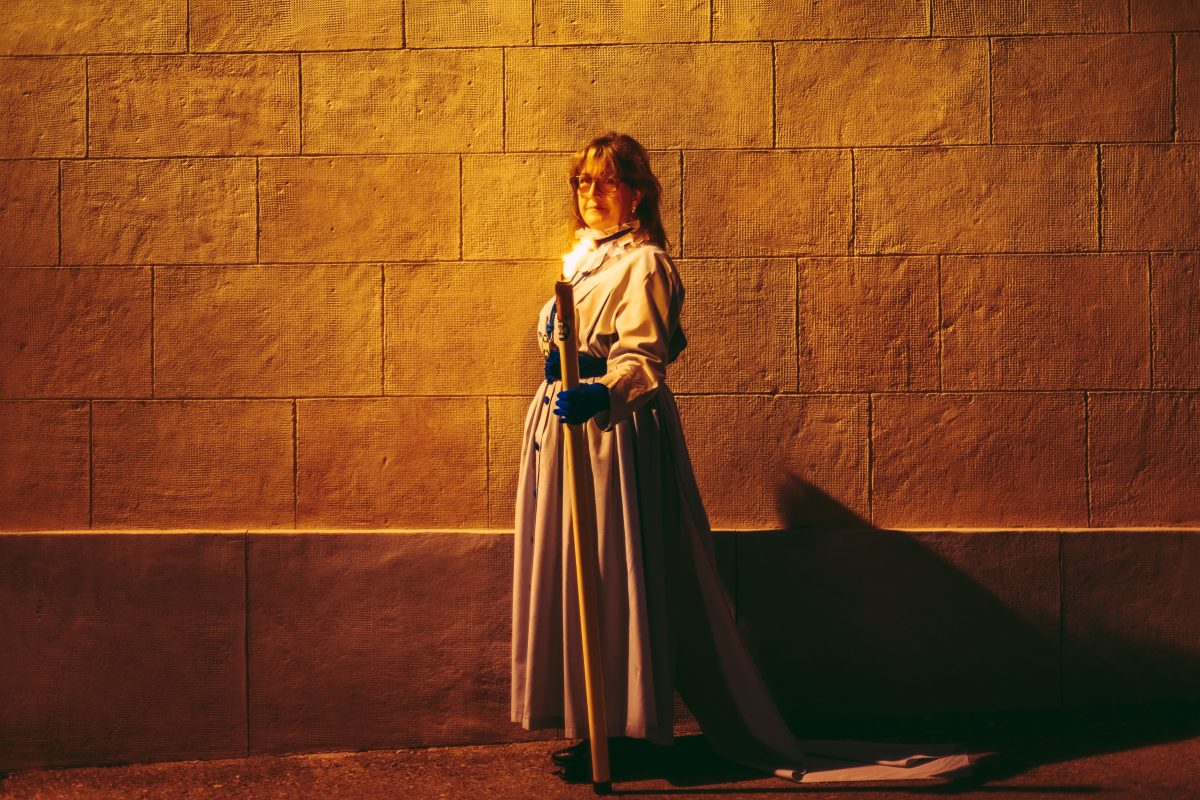 Tarragona, Spain. 7 April, 2023: A member of the Brotherhood of 'Cofradia Dels Pescadors' holding a candle takes part in the Good Friday procession in Tarragona.