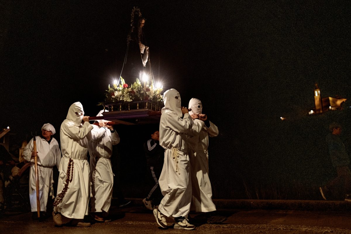 Masked penitents brotherhood take part in the 'Vera Cruz' procession at Good Friday