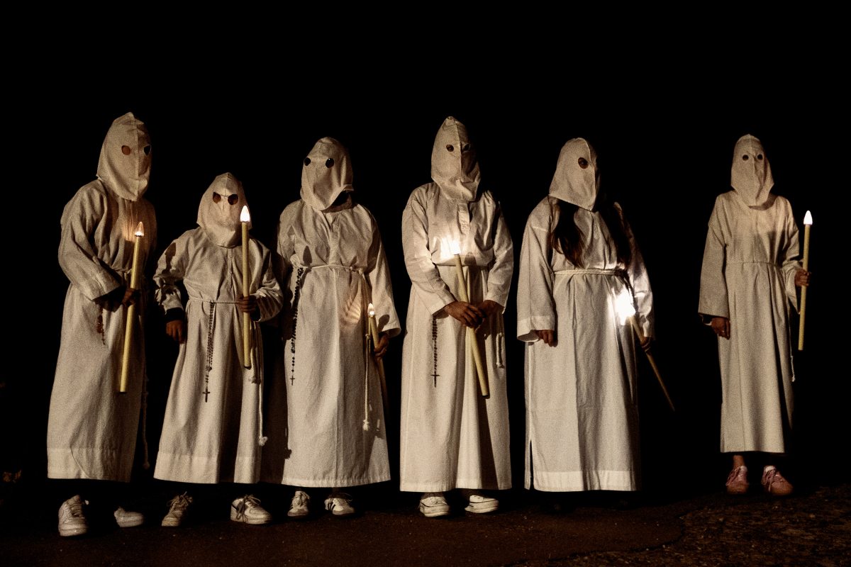 Masked penitents brotherhood take part in the 'Vera Cruz' procession at Good Friday