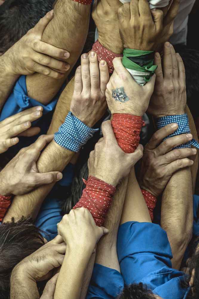 Barcelona, Spain. 20 November, 2016: The united hands of a base of a human tower by the 'Castellers de la Vila de Gracia' during a 'diada castellera' at Barcelona's Gracia quarter