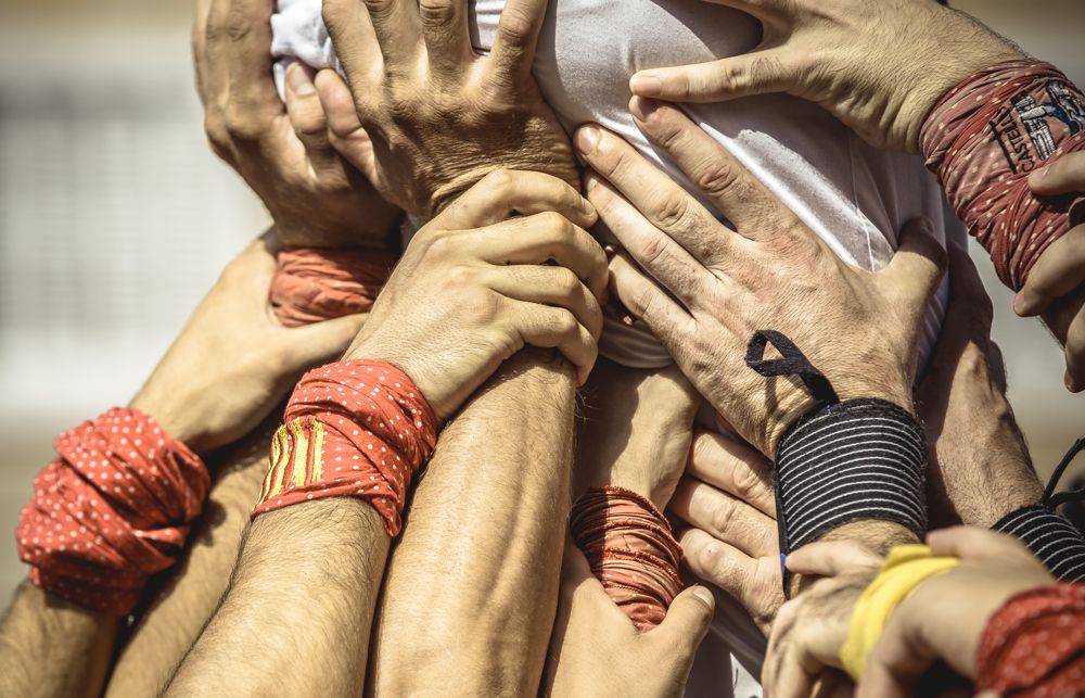 Barcelona, Spain. 24 September, 2014: The Castellers de la vila de Gracia build a human tower, '5 de  8' in the second round of the Castellers day in front of the 'Sagrada Familia'
