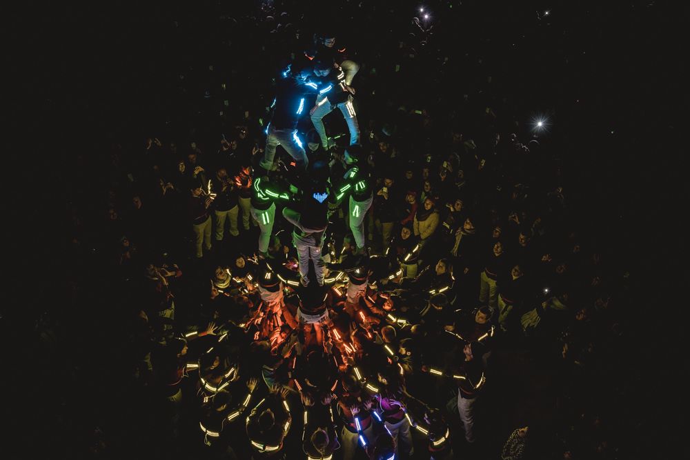 Barcelona, Spain. 6 February, 2015: The castellers of the 'Colla Jove de Barcelona' build an illuminated human tower as the festival of light and the St Eulalia festivities start in front of Barcelona's town hall.
