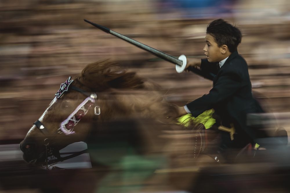 Ciutadella, Spain. 24 June, 2017: A 'caixer' (horse rider) rears up on his horse surrounded by a cheering crowd during the 'Caragol des Born' parade on the eve of the traditional 'Sant Joan' (Saint John) festival in Ciutadella de Menorca