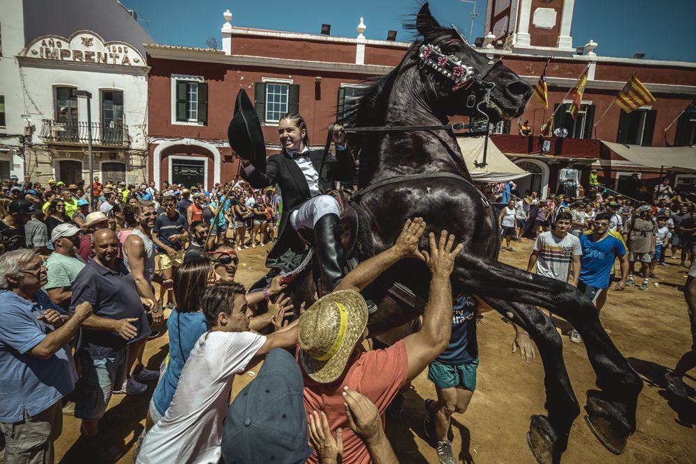 Es Castell, Spain. 25 July, 2017: A 'caixer' (horse rider) rears up on his horse surrounded by a cheering crowd during the 'Jaleo' of the traditional 'Sant Jaume' (Saint James) festival in Es Castell, the town's patron saint fiesta