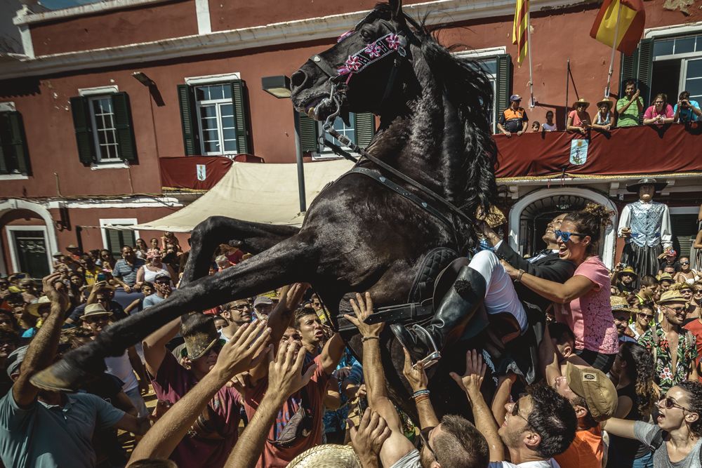 Es Castell, Spain. 25 July, 2017: A 'caixer' (horse rider) rears up on his horse surrounded by a cheering crowd during the 'Jaleo' of the traditional 'Sant Jaume' (Saint James) festival in Es Castell, the town's patron saint fiesta