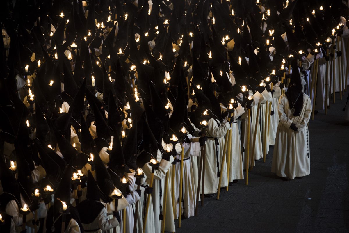 Penitents with torches gather at Zamora's Plaza Major for a chant during the Good Friday procession of the 'Nuestra Madre de las Angustias' brotherhood